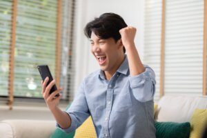 Asian,Man,Is,Smiling,And,Expressing,His,Happy,Feeling,On